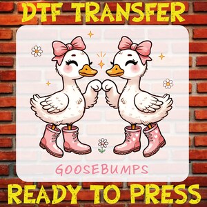 May include: Two white cartoon geese wearing pink boots and bows, facing each other with their wings outstretched. The text "GOOSEBUMPS" is below the geese, and the text "DTG TRANSFER READY TO PRESS" is at the bottom of the image.