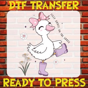 May include: A white goose with pink boots and a pink bow with white polka dots. The goose is standing on one leg and has its other leg raised. The goose is smiling and has its eyes closed. The text "Silly Goose on the Loose" is written in a circle around the goose.
