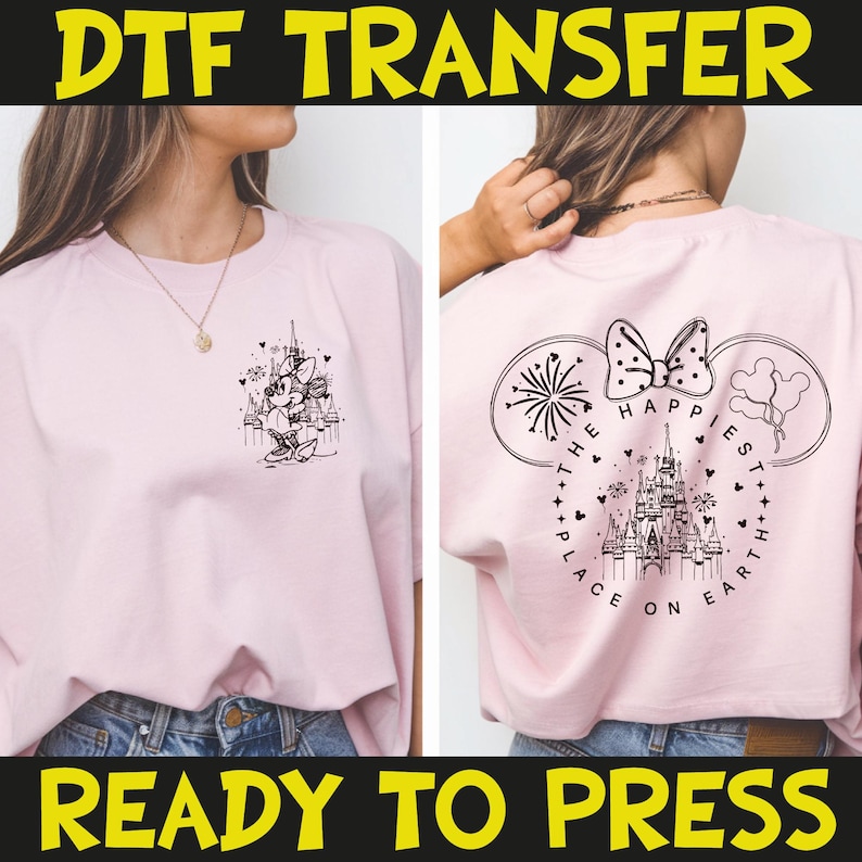 May include: Pink t-shirt with a black and white graphic of a Disney castle and Minnie Mouse on the front. The back of the shirt features a Mickey Mouse ear design with fireworks, a bow, and the text "The Happiest Place on Earth."