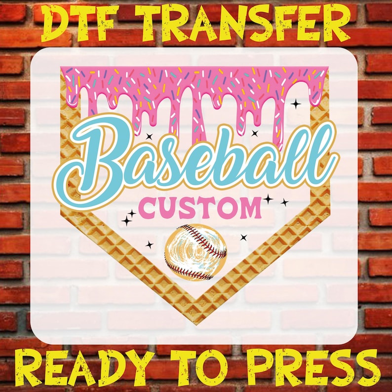 May include: A pink and blue baseball-themed iron-on transfer design with a waffle pattern, dripping pink icing, sprinkles, and a baseball. The text reads "Baseball Custom" and "Ready to Press".