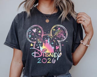 May include: Dark gray t-shirt featuring a colorful Disney design with Mickey Mouse ears, fireworks, and a castle. The text "Disney 2026" is displayed below the design. The words "DTF TRANSFER" and "READY TO PRESS" are at the top and bottom.