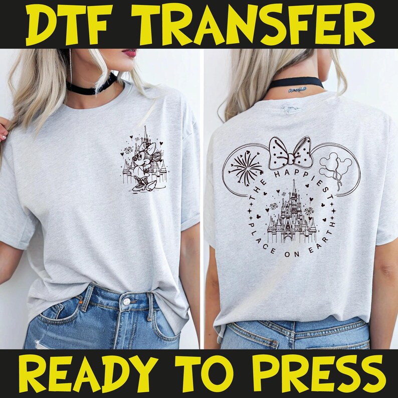 May include: Light gray t-shirt with a black graphic on the front and back. The front graphic features a cartoon character and a castle. The back graphic says "The Happiest Place on Earth" with a castle and fireworks. The text "DTF TRANSFER" and "READY TO PRESS" are at the top and bottom.