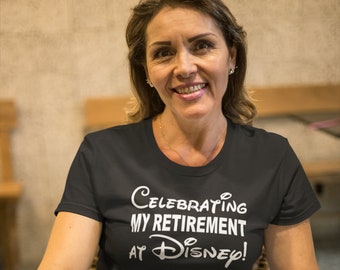May include: A woman wearing a black t-shirt with the text "Celebrating my retirement at Disney!" in white. She is sitting in a wicker chair and holding a glass of orange juice.