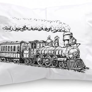 May include: A white rectangular pillowcase featuring a detailed black and white ink-style illustration of a vintage steam locomotive train. The train is depicted with a passenger car attached and a large plume of smoke billowing from the smokestack.