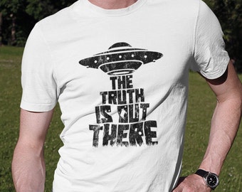 May include: White t-shirt with a black graphic of a UFO and the text "The Truth Is Out There".