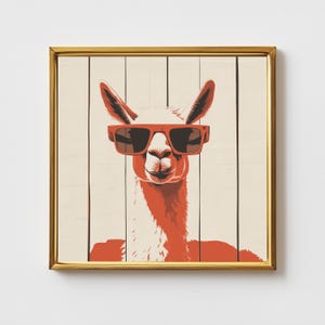May include: A framed art print featuring a stylized llama wearing red sunglasses. The llama is depicted in shades of red and white against a backdrop of vertical wooden planks. The frame is gold-colored, adding a touch of elegance to the artwork.