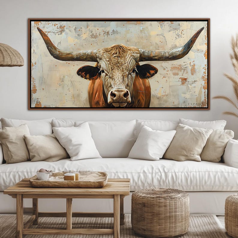 May include: A framed canvas art print depicting a longhorn bull. The bull has large, curved horns and a brown and white coat. The background has a textured, neutral colour palette.