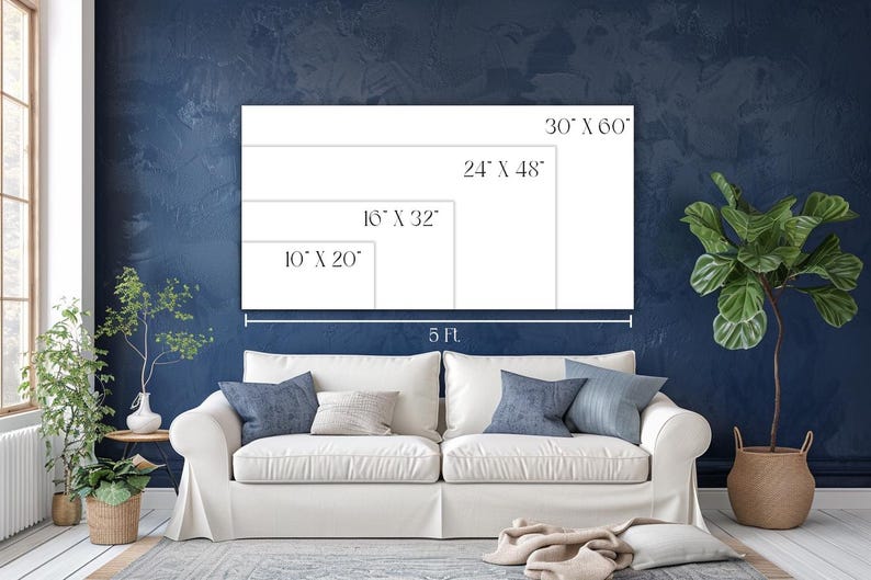 May include: A white canvas with size options: 76 cm x 152 cm, 61 cm x 122 cm, 41 cm x 81 cm, and 25 cm x 51 cm. The canvas is displayed above a white sofa with blue cushions. The wall is dark blue. A plant is in the background.