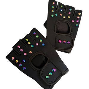 May include: A white ceramic mug with a black handle and the text "But First, Coffee" in a bold, black font. The mug is set against a blurred background, suggesting a cozy setting.