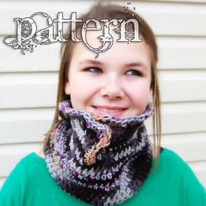 May include: A handmade crochet cowl in shades of gray, black, and purple, fastened with a button. The word "Pattern" is displayed in a decorative font above the cowl.