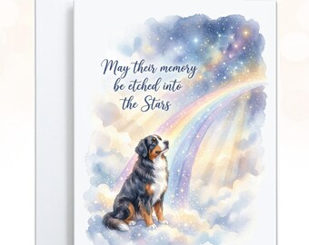 May include: A greeting card featuring a watercolor illustration of a Bernese Mountain Dog sitting on clouds, looking up at a rainbow and a starry night sky. The text reads, May their memory be etched into the Stars, in dark blue script.