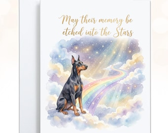 May include: A white greeting card featuring a watercolor illustration of a black and tan Doberman sitting on clouds. A rainbow path leads into a starry sky with the gold text, May their memory be etched into the Stars, printed above the dog.