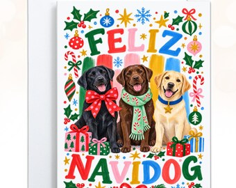 May include: A greeting card featuring a black, chocolate, and yellow Labrador Retriever sitting with wrapped gifts. The black dog wears a red polka-dot bow, the chocolate dog a candy cane scarf, and the yellow dog a blue collar. Text reads FELIZ NAVIDOG.