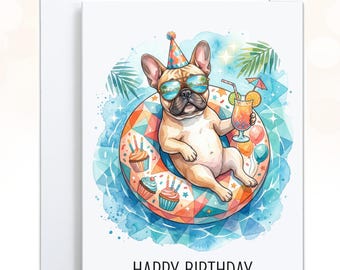 May include: A white greeting card featuring a watercolor illustration of a tan French Bulldog wearing a party hat and sunglasses, floating on a colorful geometric pool float with cupcakes, holding a tropical drink, with the text HAPPY BIRTHDAY.