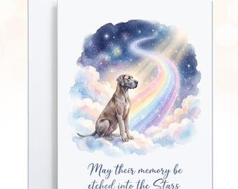 May include: A white greeting card featuring a watercolor illustration of a brown dog sitting on clouds. A rainbow path leads into a starry night sky. The text below the illustration reads, May their memory be etched into the Stars.