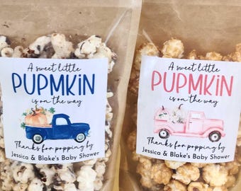 May include: Two clear stand-up pouches filled with popcorn. Each label features the text A sweet little PUPMKIN is on the way and Thanks for popping by Jessica & Blake's Baby Shower. One label shows a blue truck, the other a pink truck.