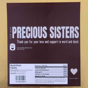 May include: A brown card with white text that reads "Precious Sisters" and "Thank you for your love and support in word and deed." The card also includes a nutrition facts table with a heart icon and the text "Agape Love" and "Net Worth Priceless (1 Peter 3:4)".