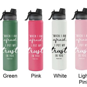 May include: A range of insulated water bottles in colours such as purple, black, green, pink, white, light pink, aqua, blue, and grey. Each bottle has a black lid and the text "WHEN I AM afraid I PUT MY trust IN YOU" in white.