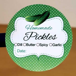 May include: A green and white polka dot round sticker with a white label that says "Homemade Pickles" with checkboxes for "Dill", "Butter", "Spicy", and "Garlic". There is a space for a date and a drawing of two green pickles.