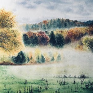 May include: Watercolor painting of a misty landscape. The artwork depicts a field of green grass in the foreground, with trees and a forest in the background. The sky is a light blue with some clouds. The colors are soft and muted.