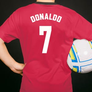 Red soccer jersey with white text and numbers. The text reads "DONALDO" and the number is "7".
