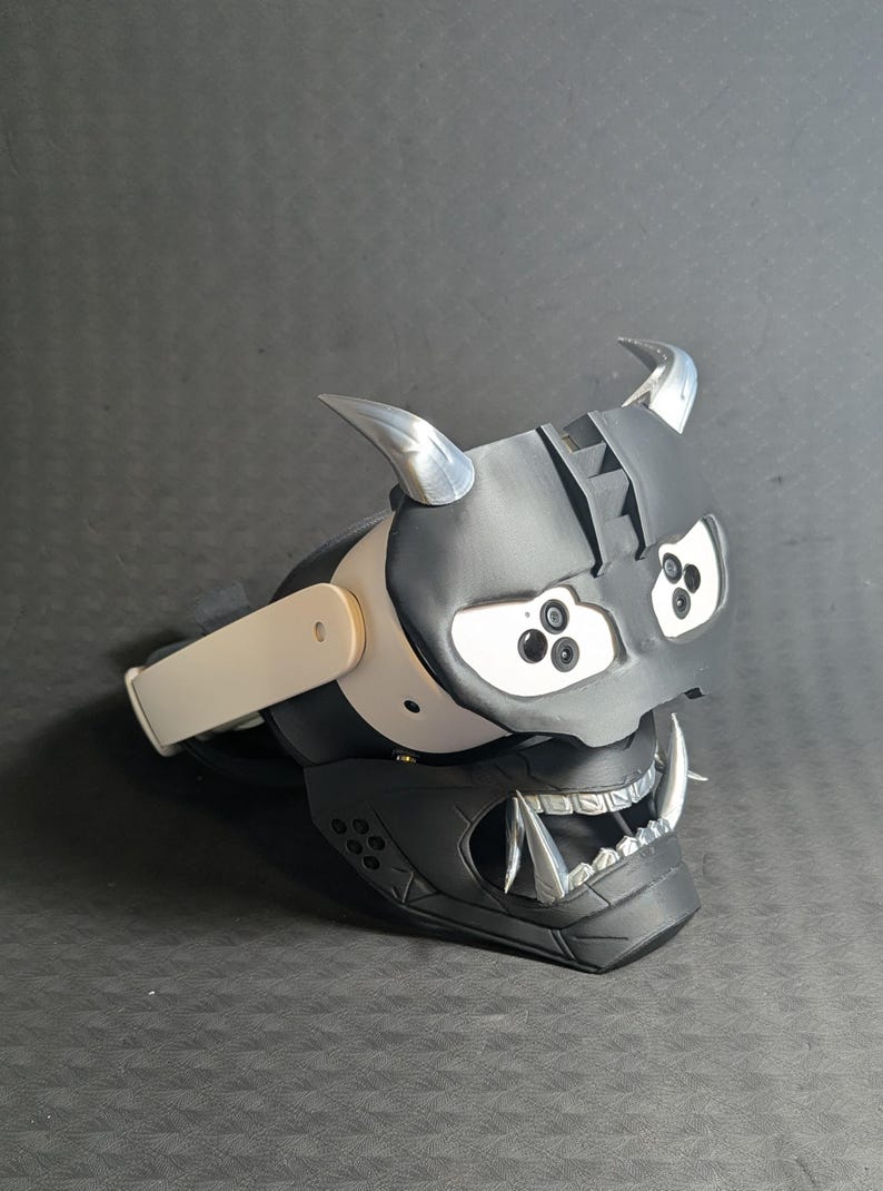 Side view of the full Cyber Oni mask set in black and silver over the Meta Quest 3s headset with an elite strap.