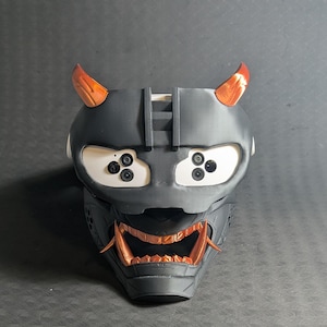 Front view of the full Cyber Oni mask set in black and copper over the Meta Quest 3s headset with an elite strap.