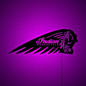 May include: Black metal Indian Motorcycle logo with a feather design, illuminated by a purple light. The logo includes the text "Indian MOTORCYCLE" in a cursive font. The image is set against a purple background.