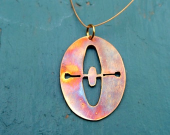 May include: A copper-toned necklace with a pendant shaped like a kayak with an oar. The pendant has a burnished finish and a rustic look.