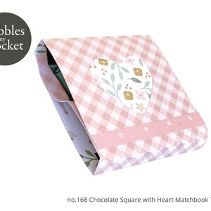 May include: A pink and white gingham patterned matchbook template with a heart-shaped window featuring a floral design. The template is labeled "no. 168 Chocolate Square with Heart Matchbook Template".