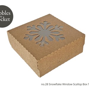May include: A brown cardboard box with a snowflake window cut out. The box is labeled "no. 28 Snowflake Window Scallop Box Template".