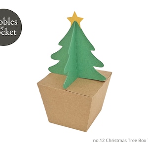 Könnte beinhalten: Eine braune Pappbox in Form eines Weihnachtsbaums mit einem grünen Papier-Baumtopper und einem gelben Stern oben. Die Box ist mit "no. 12 Christmas Tree Box Template" beschriftet.
