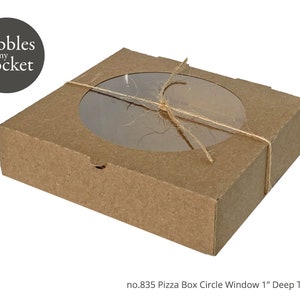 May include: A brown cardboard pizza box with a clear circle window. The box is tied with twine and has the text "Pebbles in my Pocket" printed on the top.