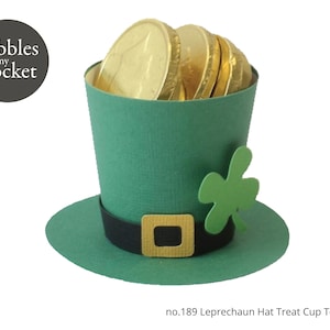 May include: A green leprechaun hat treat cup template with a gold buckle and a shamrock. The hat is filled with gold chocolate coins.