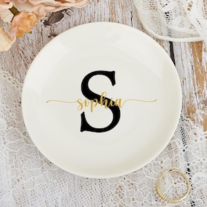 May include: White ceramic ring dish with a black letter "S" and the name "Sophia" written in gold script.