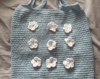 Blue crochet bag with white flowers