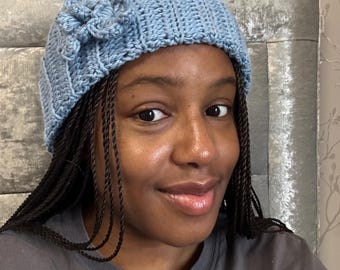 Crocheted baby blue beanie with attached flowers