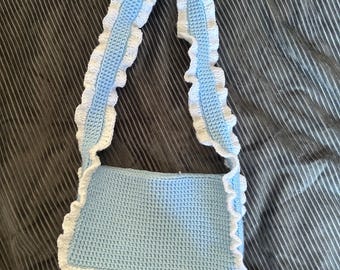 Baby blue crocheted bag with white ruffles