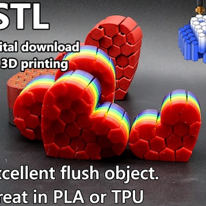 May include: Red 3D-printed heart-shaped objects with rainbow-colored layers. The image includes the text ".STL digital download for 3D printing" and "Excellent flush object. Great in PLA or TPU."