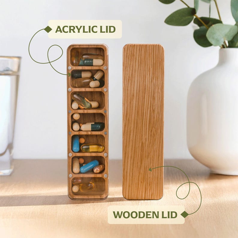 May include: A wooden pill organiser with an acrylic lid, filled with various pills and capsules. The organiser has seven compartments, each holding different medications. The wooden lid is separate. The text "ACRYLIC LID" and "WOODEN LID" are visible.
