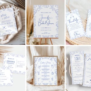 Pode incluir: Uma coleção de artigos de papelaria para chá de panela em azul e branco, incluindo convites, menus e uma placa de boas-vindas. Os designs apresentam motivos florais e de conchas, com fontes de script elegantes. A papelaria é organizada em uma bandeja de madeira e uma cesta de vime.