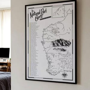 May include: A framed black and white map titled The National Park Quest Western Australia. The print features a detailed outline of the state, illustrations of landscapes, a compass rose, and a numbered checklist of national parks.
