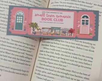 May include: A pink and gray bookmark with a pink door and a small town scene. The bookmark says "Life-time Member of the Small Town Romance Book Club".