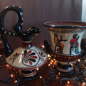 May include: A set of three ceramic mugs with a speckled, matte finish. The mugs are in shades of cream, light brown, and dark brown. Each mug has a simple, minimalist design, perfect for coffee or tea.