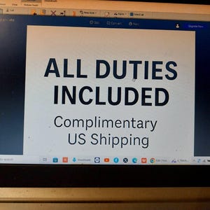May include: A digital screen displaying a white rectangular graphic with dark blue text. The text reads ALL DUTIES INCLUDED in large capital letters, followed by the smaller text Complimentary US Shipping centered below the main heading.