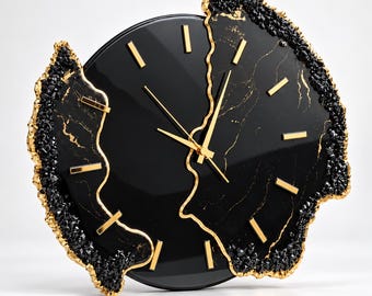 May include: A circular wall clock featuring a glossy black face with gold-colored hour markers and hands. The clock is framed by irregular, jagged edges of black crystalline textures with gold-painted borders, creating a geode-inspired appearance.