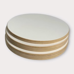 May include: A stack of three circular wooden embroidery hoops, each featuring a smooth, light-colored wooden frame and a white fabric surface stretched taut across the center, creating a layered, cylindrical appearance with visible wood grain.