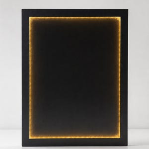 May include: A rectangular black frame featuring an integrated internal light source that creates a warm, glowing golden border around the inner perimeter. The central area remains dark, contrasting with the bright, illuminated edges of the frame.