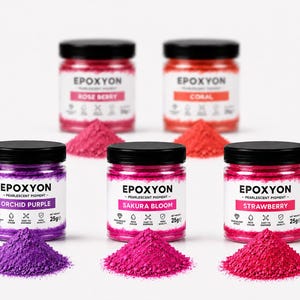 May include: An assortment of pearlescent pigments in small jars with black lids. The jars are labeled "Rose Berry", "Coral", "Orchid Purple", "Sakura Bloom", and "Strawberry". Each jar is accompanied by a small pile of matching colored pigment.