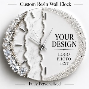 May include: A round custom resin wall clock featuring a white marble-patterned section, silver clock hands, and silver hour markers. The left edge is adorned with clear crystals, while the right side displays the text YOUR DESIGN LOGO PHOTO TEXT.